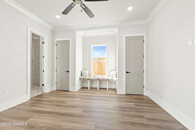 unfurnished bedroom with ceiling fan, ornamental molding, light hardwood / wood-style floors, and ensuite bathroom