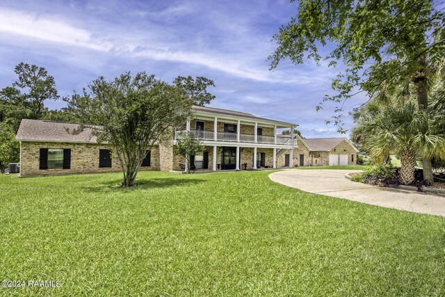 415 Fort Hamilton Dr, Opelousas, LA 70570 - exterior space with driveway, a balcony, a front lawn, brick siding, and a garage