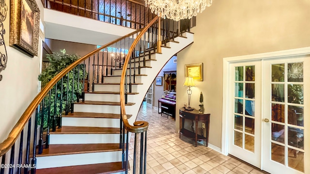 stairs featuring a towering ceiling, tile patterned flooring, and french doors