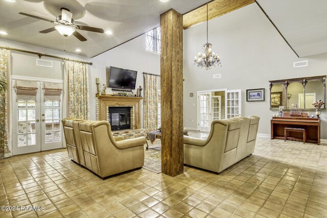 415 Fort Hamilton Dr, Opelousas, LA 70570 - living area with a wealth of natural light, french doors, high vaulted ceiling, and ceiling fan with notable chandelier