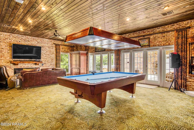 playroom with carpet floors, wooden ceiling, brick wall, and a brick fireplace