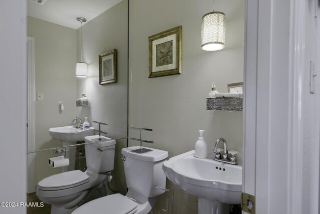 415 Fort Hamilton Dr, Opelousas, LA 70570 - half bathroom with visible vents, toilet, and a sink