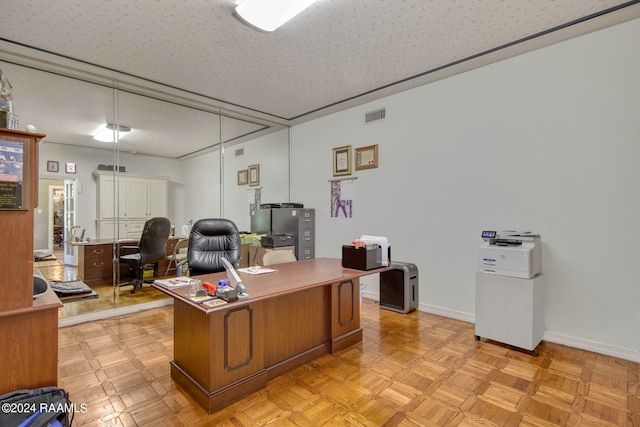 office area featuring a textured ceiling and light parquet flooring