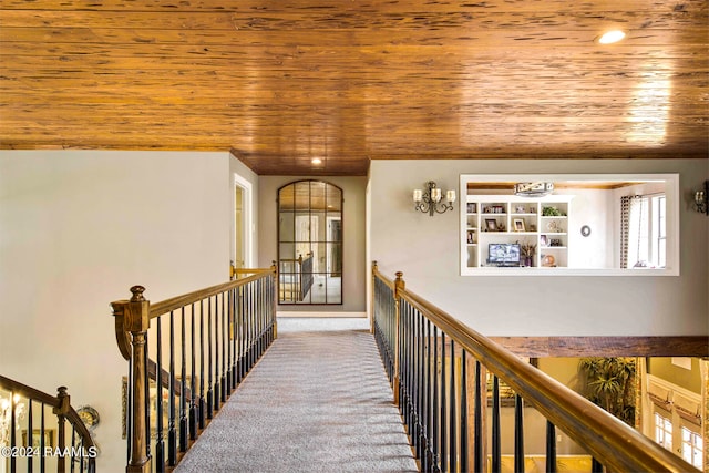 corridor with wood ceiling and carpet floors