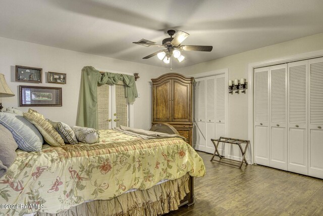 415 Fort Hamilton Dr, Opelousas, LA 70570 - bedroom featuring visible vents, wood finished floors, a ceiling fan, and two closets