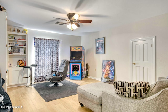 living room featuring ceiling fan and light hardwood / wood-style flooring