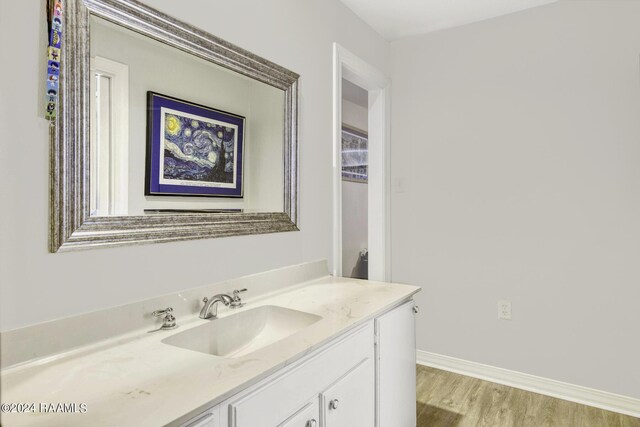 415 Fort Hamilton Dr, Opelousas, LA 70570 - bathroom featuring baseboards, wood finished floors, and vanity