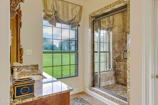 bathroom featuring tile patterned flooring, vanity, and a shower with shower door