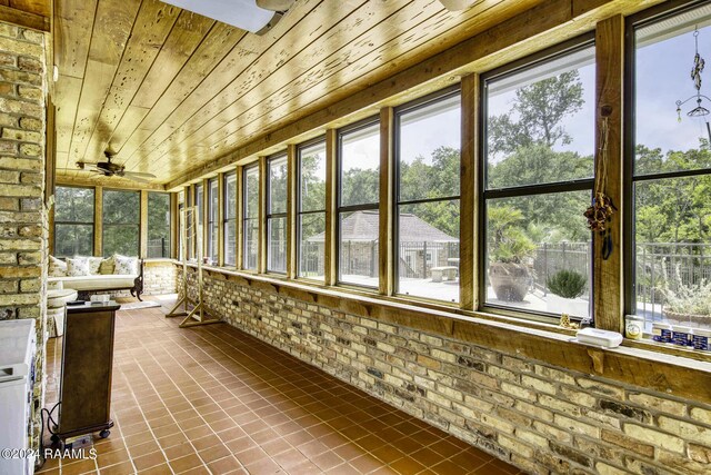 415 Fort Hamilton Dr, Opelousas, LA 70570 - unfurnished sunroom with brick wall, tile patterned flooring, and wooden ceiling