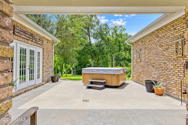 view of patio / terrace featuring a hot tub and french doors