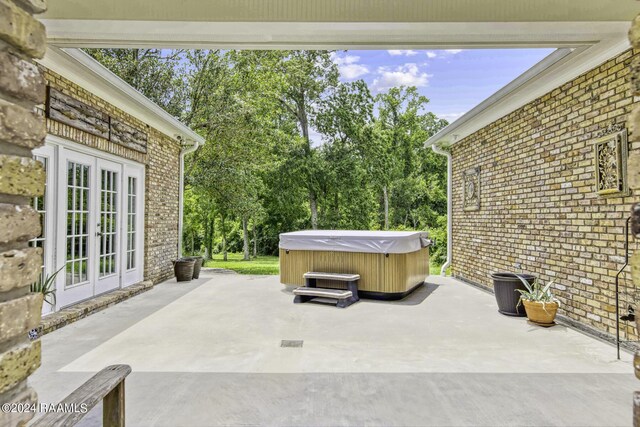 415 Fort Hamilton Dr, Opelousas, LA 70570 - view of patio / terrace featuring french doors and a hot tub