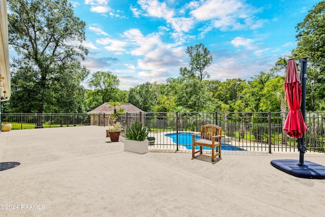 view of patio / terrace with a fenced in pool