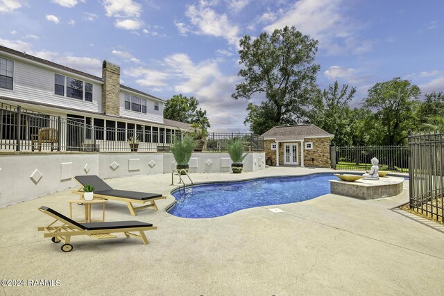 415 Fort Hamilton Dr, Opelousas, LA 70570 - view of swimming pool with a patio area, an outdoor structure, a fenced in pool, a storage structure, and fence