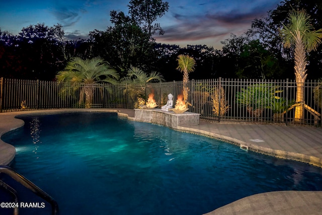 view of pool at dusk