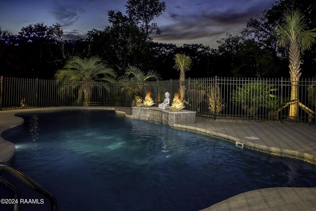 415 Fort Hamilton Dr, Opelousas, LA 70570 - pool at dusk featuring a fenced backyard and a fenced in pool