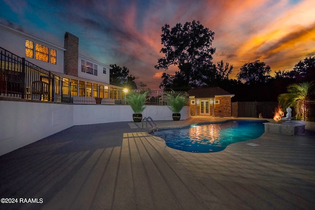 pool at dusk with a patio