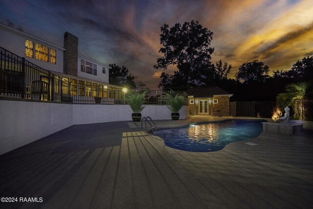 415 Fort Hamilton Dr, Opelousas, LA 70570 - pool at dusk with a patio area, a fenced in pool, a storage structure, french doors, and fence