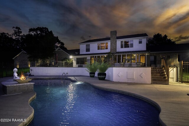 415 Fort Hamilton Dr, Opelousas, LA 70570 - pool at dusk featuring fence, stairs, a patio, and a fenced in pool