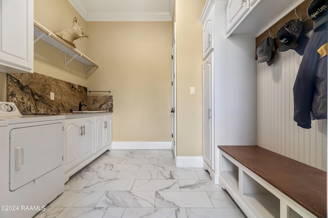 laundry area with baseboards, marble finish floor, cabinet space, washer / clothes dryer, and crown molding