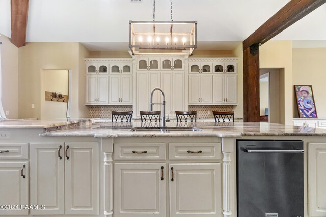 kitchen with sink, dishwasher, light stone countertops, and tasteful backsplash