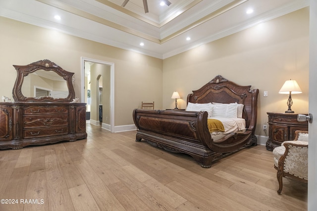 bedroom with light wood finished floors, baseboards, arched walkways, crown molding, and recessed lighting