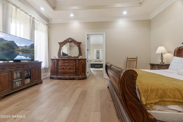 bedroom featuring light wood finished floors, a tray ceiling, crown molding, and recessed lighting