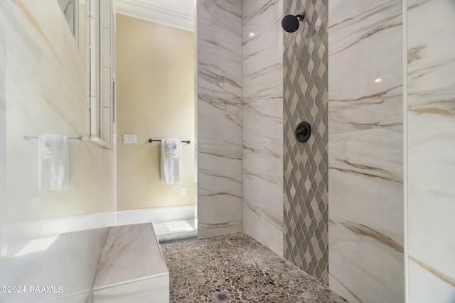 bathroom featuring a marble finish shower and crown molding