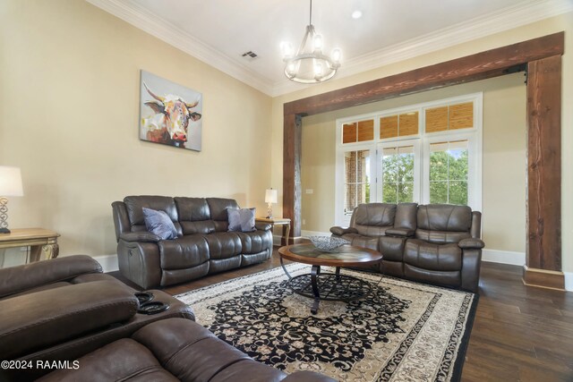 living room featuring a notable chandelier, dark wood-type flooring, and ornamental molding