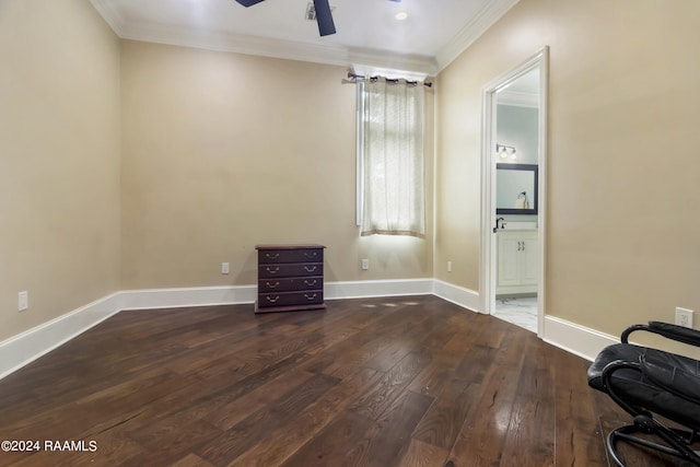 empty room featuring crown molding, baseboards, ceiling fan, and dark wood-type flooring