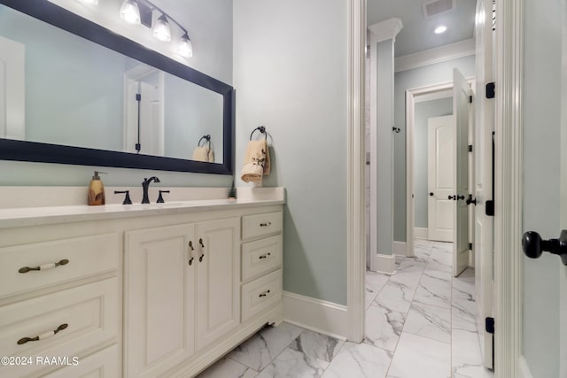 bathroom featuring baseboards, visible vents, ornamental molding, marble finish floor, and vanity