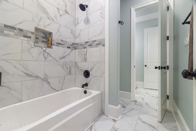 bathroom with shower / bath combination, marble finish floor, and baseboards