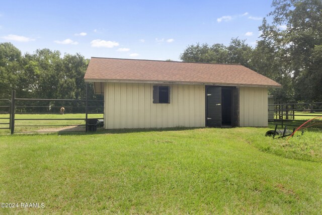 view of outbuilding with a yard