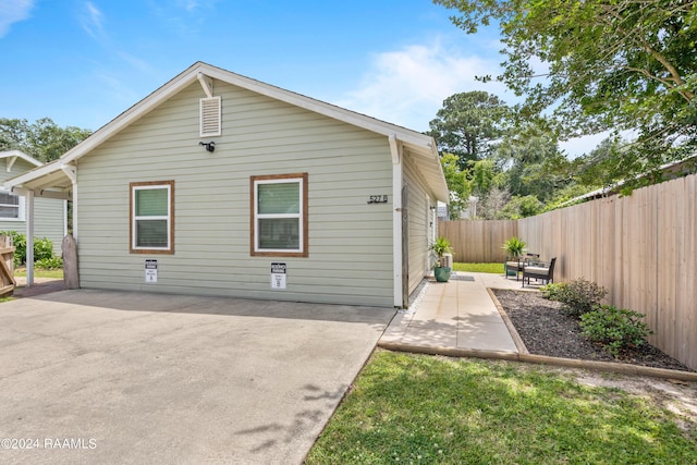 rear view of house featuring a patio and a fenced backyard