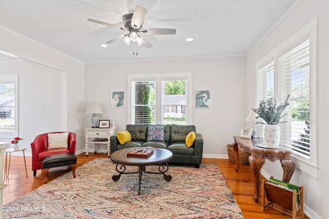 living room with a healthy amount of sunlight, baseboards, and ornamental molding