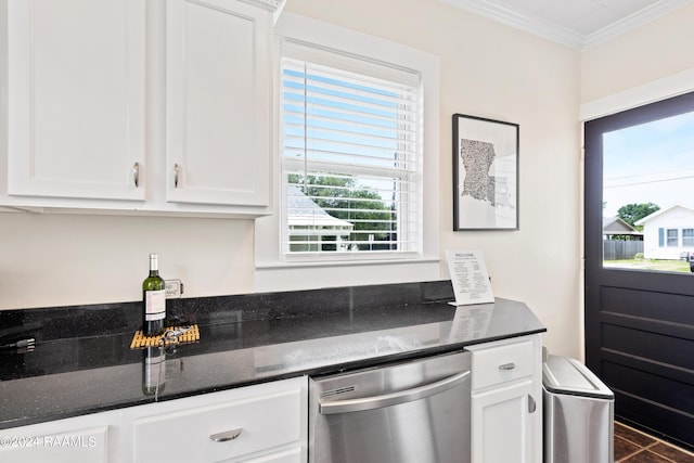 kitchen with stainless steel dishwasher, dark stone countertops, white cabinets, and crown molding