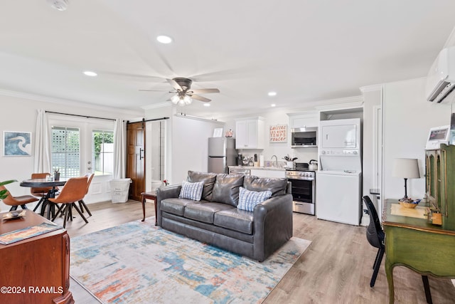 living area featuring light wood-style floors, recessed lighting, stacked washer and clothes dryer, and crown molding