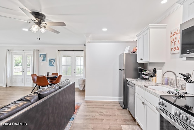 kitchen featuring ornamental molding, french doors, a wealth of natural light, and appliances with stainless steel finishes