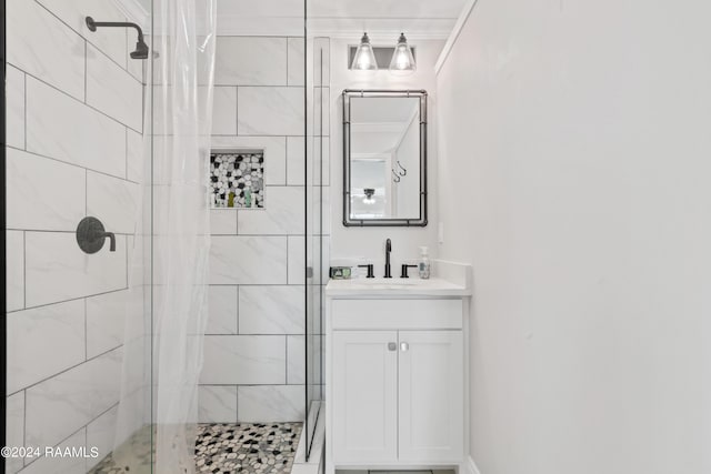 bathroom featuring a shower stall, crown molding, and vanity