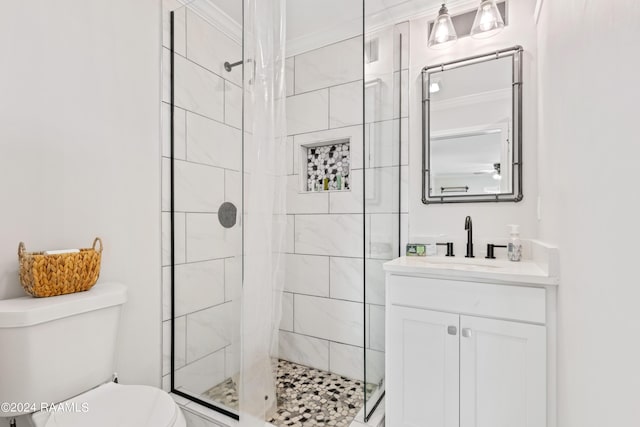 full bathroom with a stall shower, vanity, toilet, and crown molding