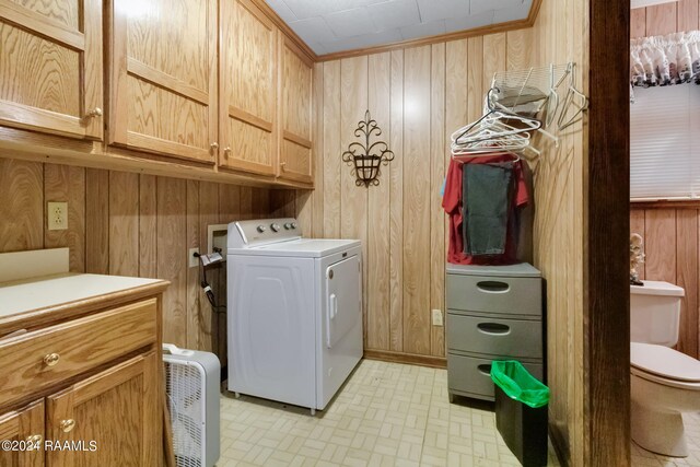 935 Pearl St, Rayne, LA 70578 - laundry room with washer / dryer, wooden walls, and cabinet space
