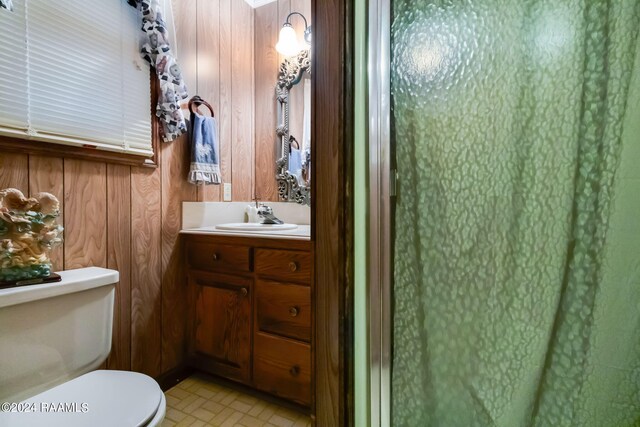 935 Pearl St, Rayne, LA 70578 - bathroom with wood walls, vanity, and toilet