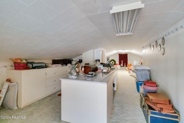 935 Pearl St, Rayne, LA 70578 - interior space with light countertops, open floor plan, white cabinets, and vaulted ceiling