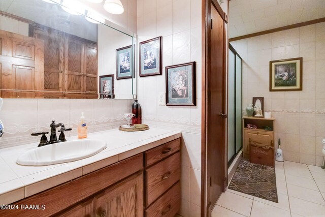 935 Pearl St, Rayne, LA 70578 - full bathroom featuring tile patterned floors, tile walls, a shower stall, and vanity