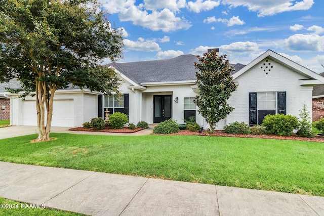 ranch-style home featuring a garage and a front yard