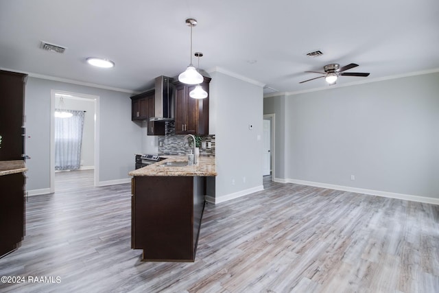 kitchen featuring ceiling fan, light wood-type flooring, decorative backsplash, dark brown cabinetry, and light stone countertops