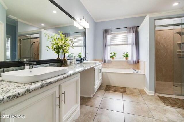 bathroom featuring tile patterned flooring, plus walk in shower, crown molding, and dual bowl vanity