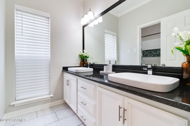 bathroom featuring tile patterned flooring, double sink vanity, and crown molding