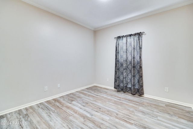 unfurnished room featuring light hardwood / wood-style floors and ornamental molding