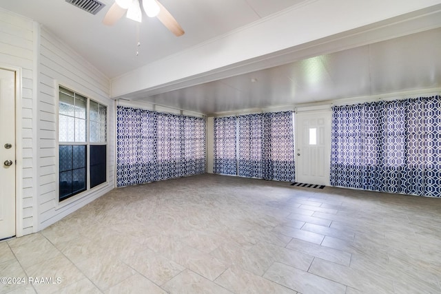 unfurnished room with ceiling fan, plenty of natural light, and tile patterned flooring