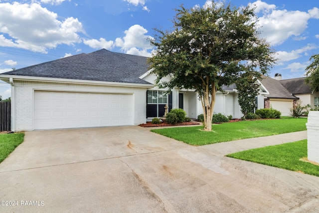 view of front facade with a front yard and a garage